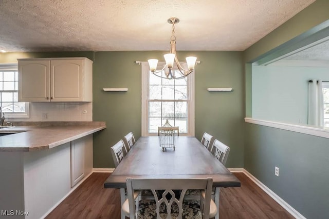 dining area featuring dark wood-type flooring and a wealth of natural light