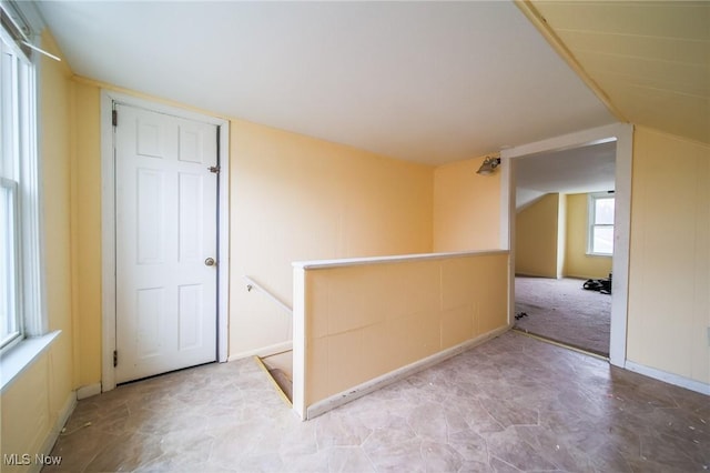 empty room featuring vaulted ceiling