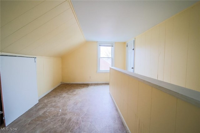 additional living space featuring vaulted ceiling