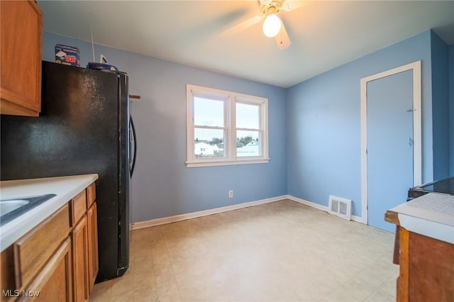 kitchen featuring black refrigerator and ceiling fan