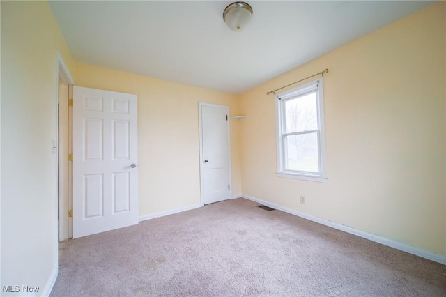 unfurnished bedroom with light colored carpet