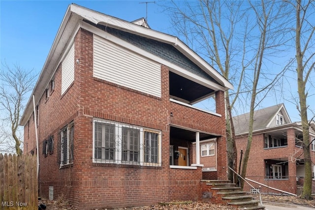 view of front of house featuring a balcony