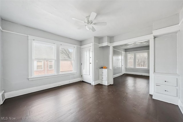 unfurnished room with dark hardwood / wood-style flooring and ceiling fan