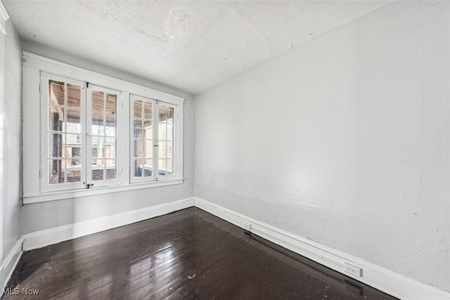 unfurnished room with wood-type flooring