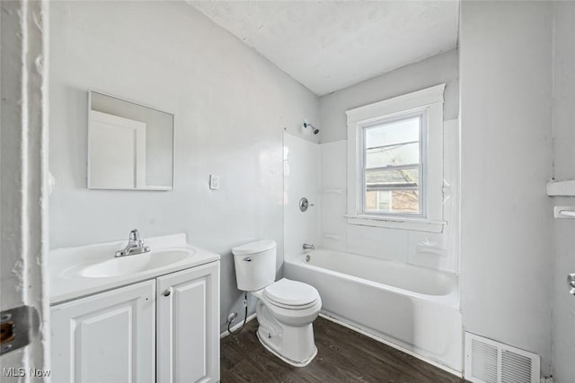 full bathroom featuring vanity, hardwood / wood-style floors, shower / tub combination, and toilet