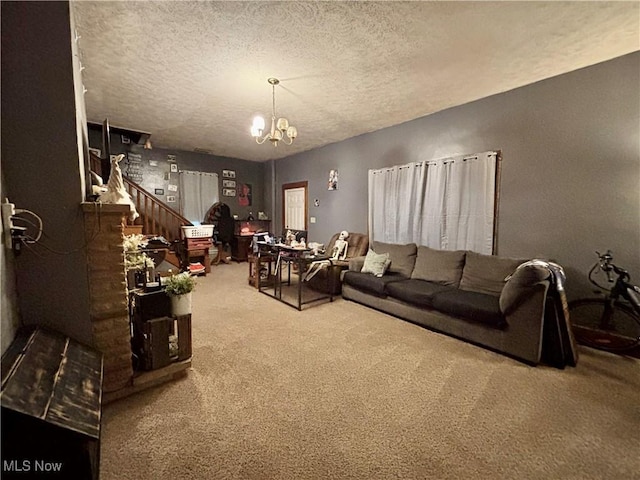 carpeted living room featuring a textured ceiling and a notable chandelier