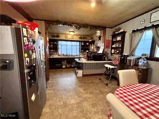 kitchen featuring stainless steel refrigerator with ice dispenser