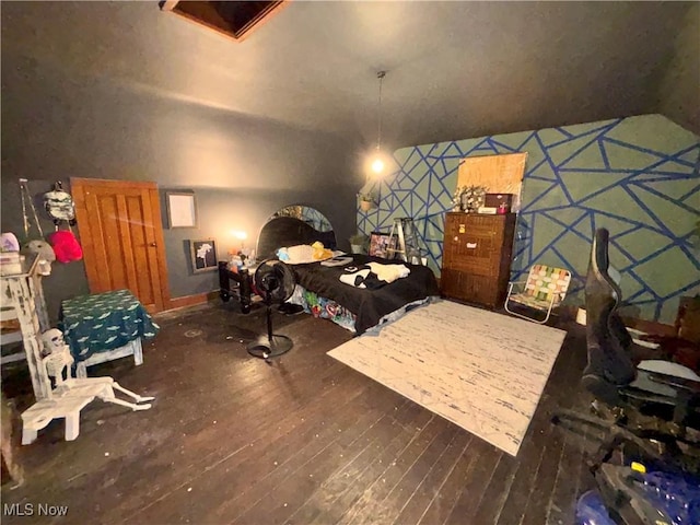 bedroom featuring lofted ceiling and dark hardwood / wood-style flooring