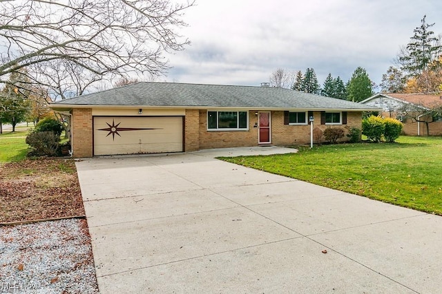 ranch-style house with a garage and a front lawn