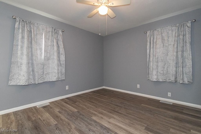 unfurnished room with dark wood-type flooring and ceiling fan