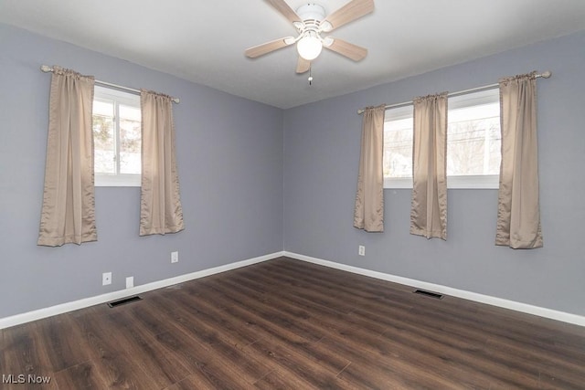 spare room with dark hardwood / wood-style floors and ceiling fan