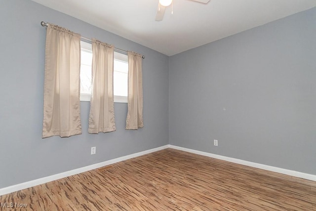 spare room with wood-type flooring and ceiling fan