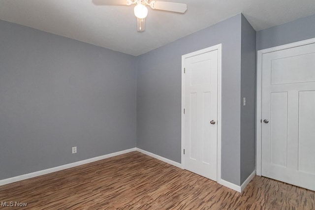 unfurnished bedroom featuring hardwood / wood-style flooring and ceiling fan