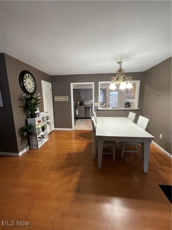 dining room with a notable chandelier and light hardwood / wood-style floors