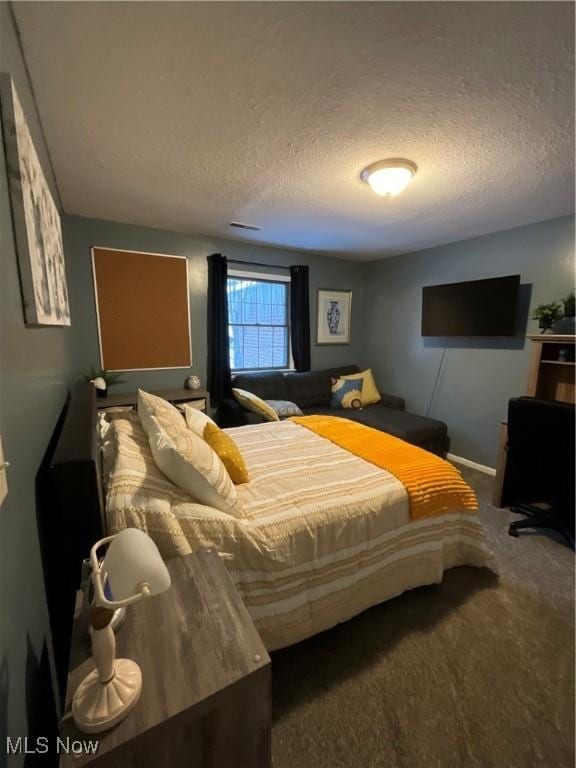 carpeted bedroom with a textured ceiling