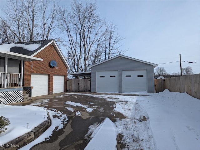 snow covered property with a garage