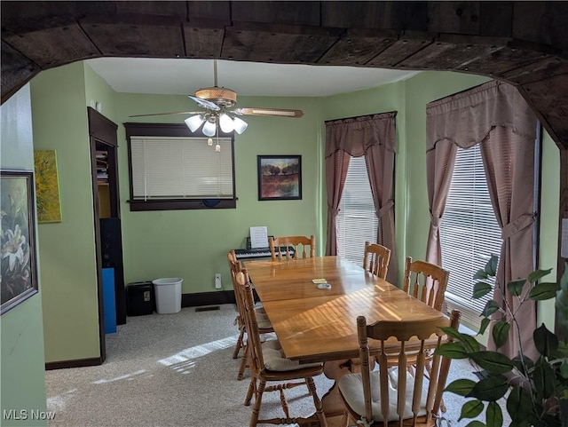 dining room with light colored carpet and ceiling fan