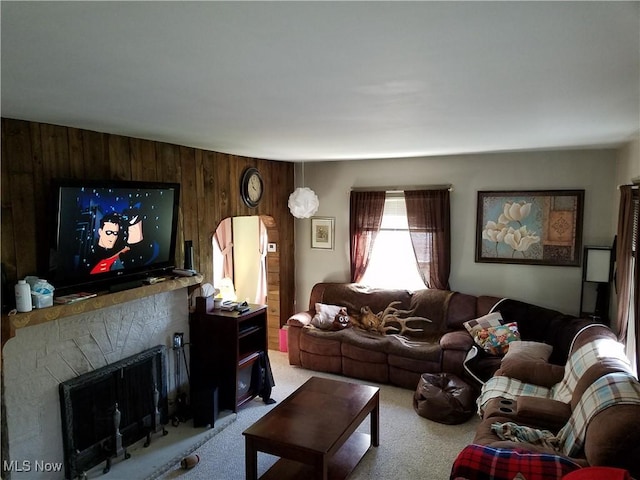 living room featuring light colored carpet and wood walls