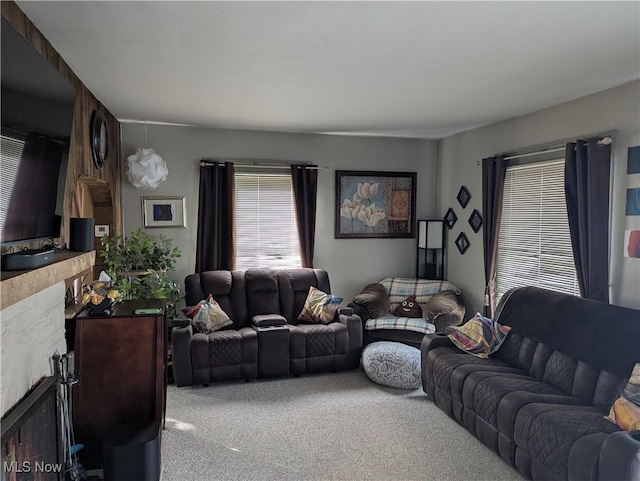 living room with a fireplace and carpet floors