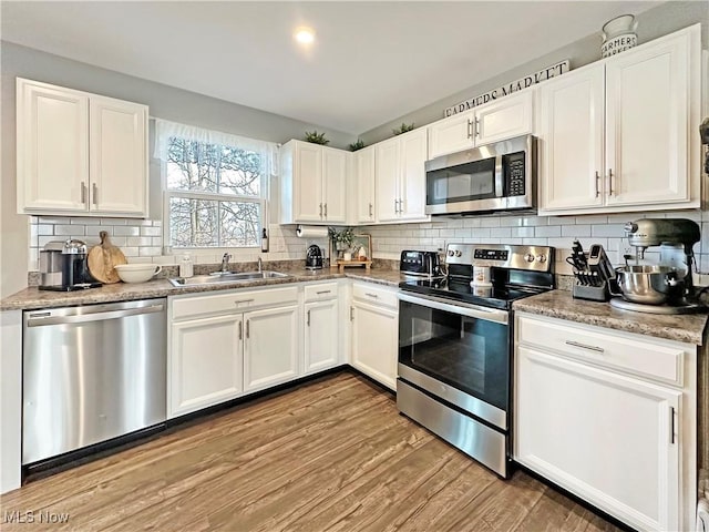 kitchen featuring white cabinetry, sink, and appliances with stainless steel finishes