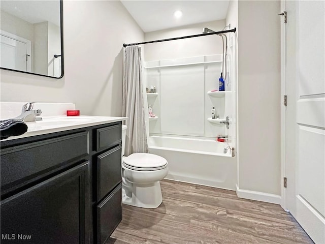 full bathroom with shower / tub combo with curtain, vanity, hardwood / wood-style flooring, and toilet