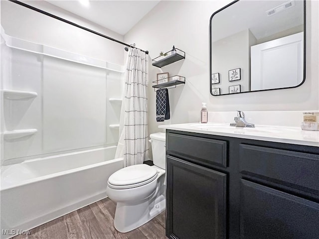 full bathroom featuring vanity, toilet, hardwood / wood-style floors, and shower / bath combo with shower curtain