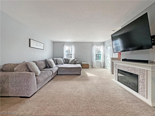 carpeted living room with a textured ceiling