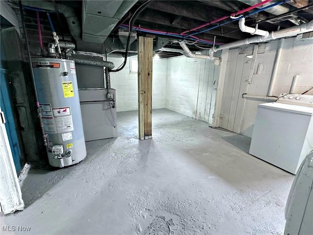 basement featuring heating unit, washer / dryer, and water heater