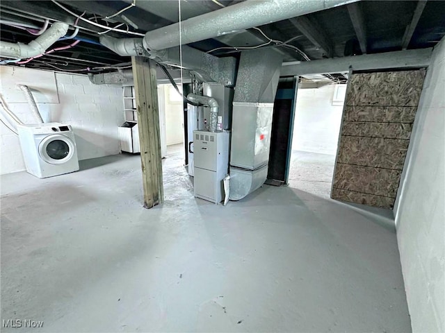 basement featuring washer / dryer and heating unit