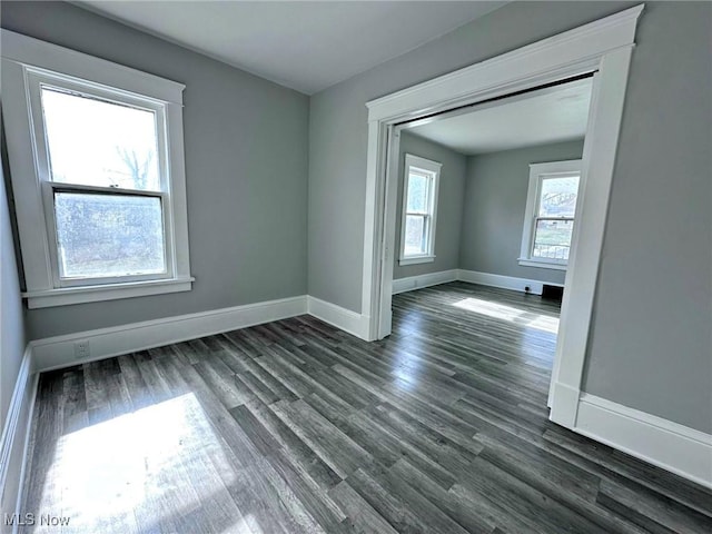 empty room with dark hardwood / wood-style flooring