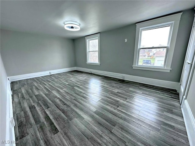 spare room featuring dark wood-type flooring