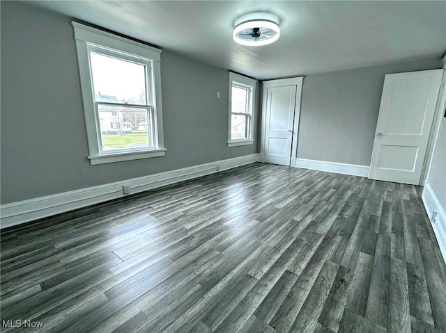 unfurnished bedroom with dark hardwood / wood-style flooring and a closet