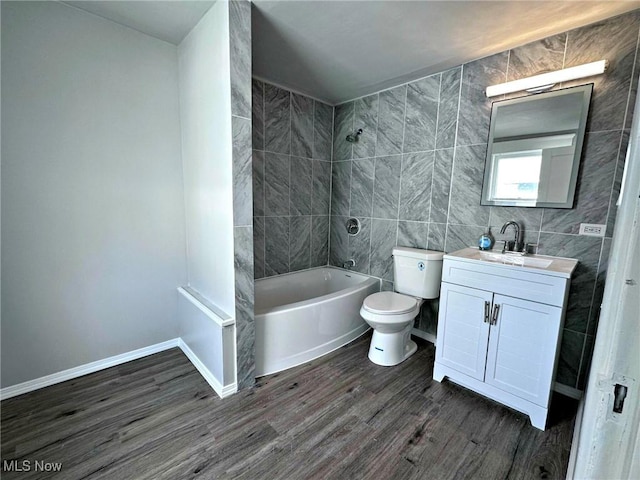 full bathroom featuring toilet, tile walls, vanity, tiled shower / bath combo, and hardwood / wood-style flooring