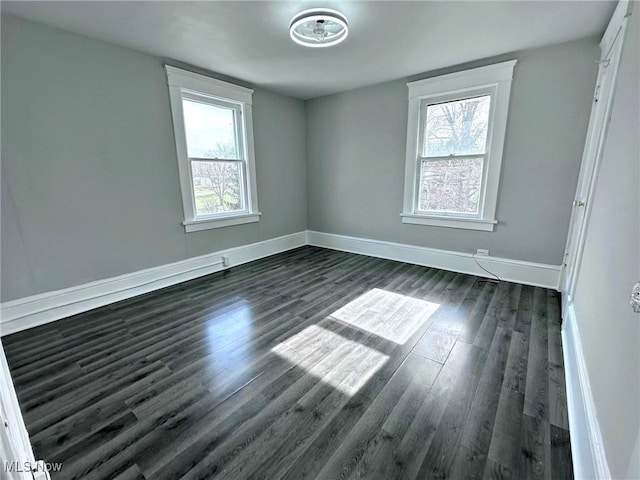 unfurnished room featuring dark hardwood / wood-style flooring