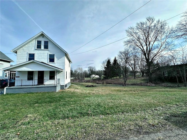 view of home's exterior with a yard and covered porch