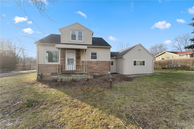 rear view of property with a yard