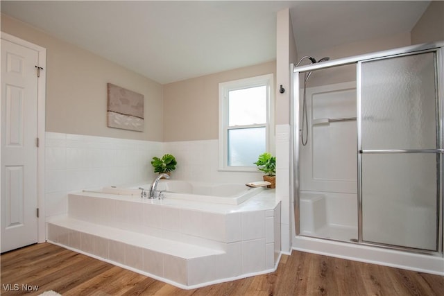 bathroom with hardwood / wood-style floors and plus walk in shower