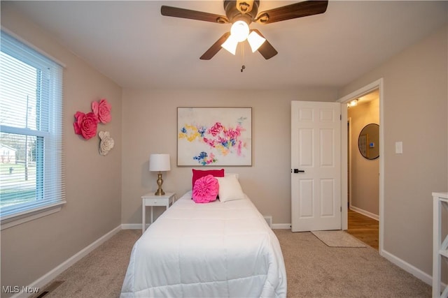 carpeted bedroom featuring ceiling fan