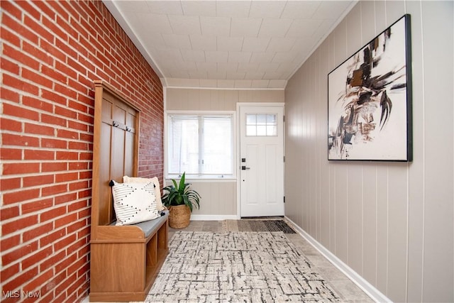 mudroom with brick wall