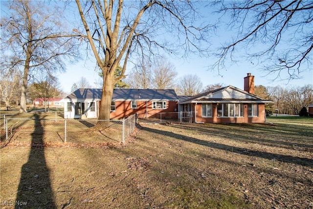 rear view of house with a lawn