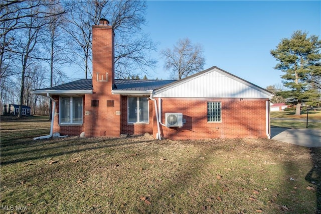 rear view of property featuring ac unit and a lawn