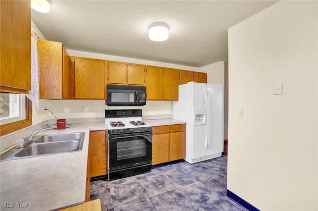 kitchen with gas range oven, sink, a textured ceiling, and white fridge with ice dispenser