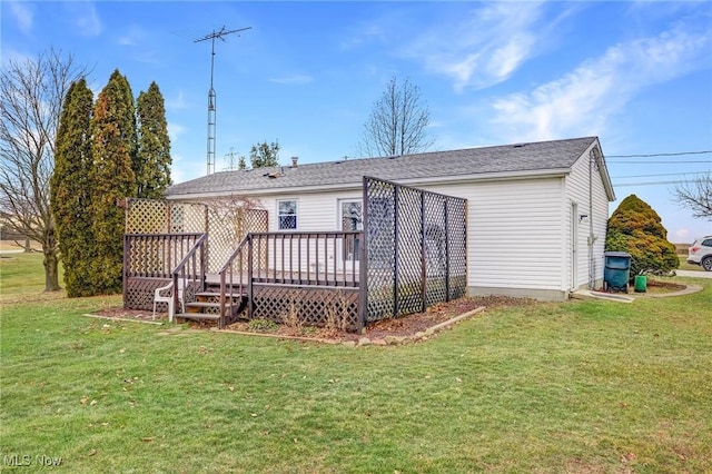 rear view of house with a yard and a deck