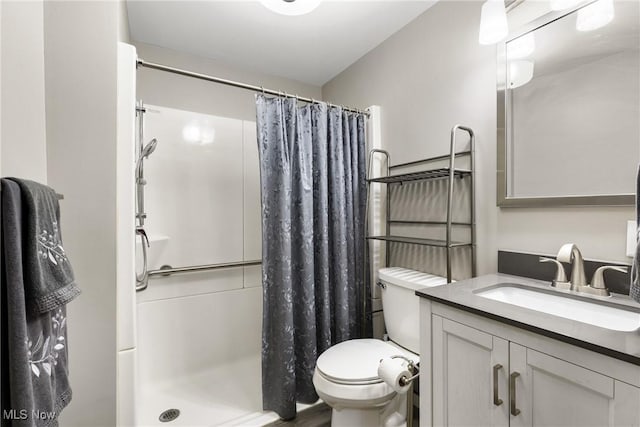 bathroom with vanity, toilet, and a shower with shower curtain