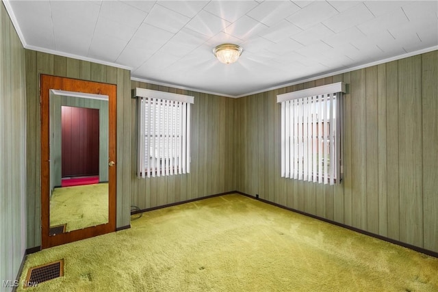 empty room with light colored carpet and ornamental molding