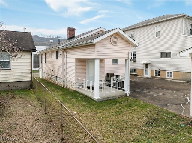 back of house with a yard and a porch