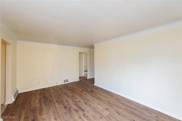 spare room with wood-type flooring