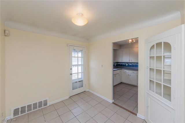 kitchen featuring light tile patterned floors and decorative backsplash