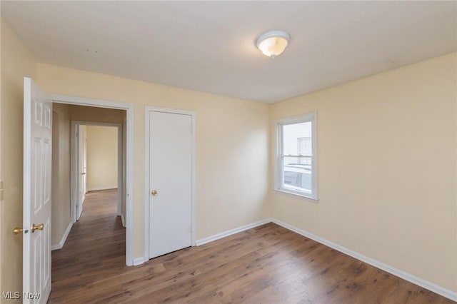 unfurnished room with dark hardwood / wood-style floors