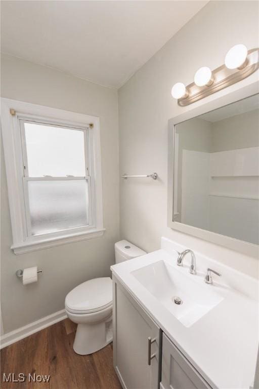 bathroom featuring vanity, hardwood / wood-style floors, and toilet